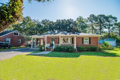 View of front facade with a garage, covered porch,