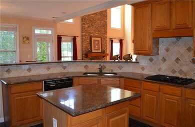 Kitchen featuring dark stone countertops, black ap
