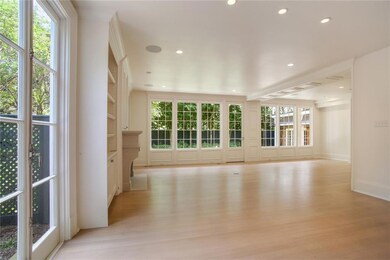 Den with Fireplace and French Doors to Grounds