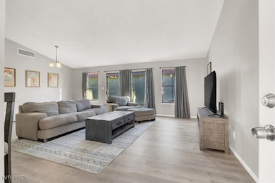 large great room with lots of natural light and new wood laminate flooring