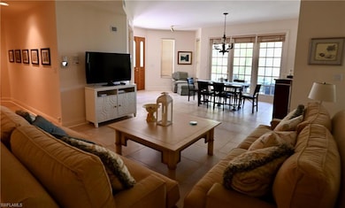 Tiled living room with a chandelier