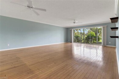 Spare room with ceiling fan, crown molding, hardwood / wood-style floors, and a textured ceiling