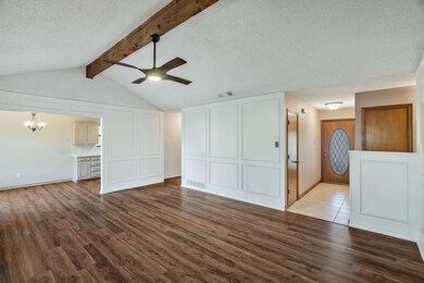 Unfurnished living room featuring a textured ceili