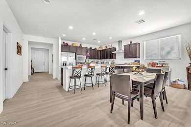 Dining room featuring light wood-type flooring and recessed lighting