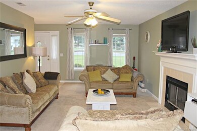 Family Room with gas fireplace and ceiling fan