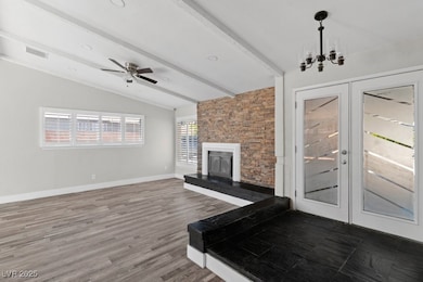 Living area with french doors, a fireplace, a chan