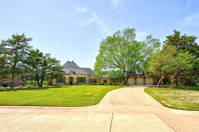 French country home featuring driveway, a front ya