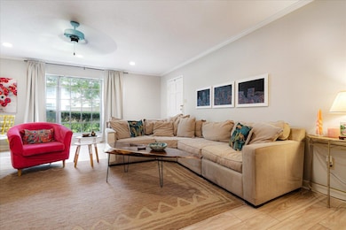 Living room with ornamental molding, recessed lighting, a ceiling fan, and light wood finished floors