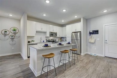 Kitchen featuring a sink, a breakfast bar area, li