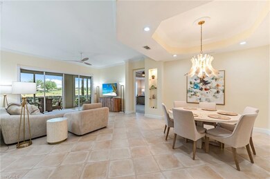 Dining room with baseboards, crown molding, a raised ceiling, and a modern chandelier