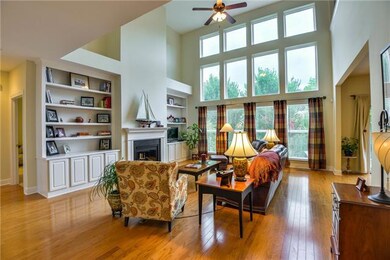 Wall of windows overlooks adds light and drama to this immaculate home
