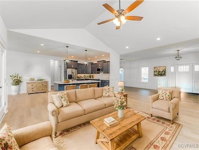 Living room with light wood-type flooring, high va