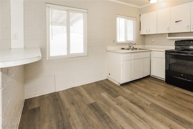 Kitchen featuring light countertops, black electri