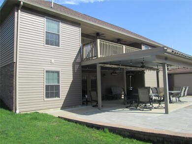 Beautiful covered rear patio with fire pit and out