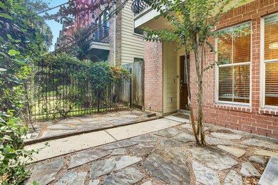 The large oak trees lining the street provide the