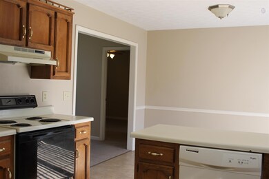 View from Kitchen back towards Dining Area. Kitchen Refrigerator to remain.   