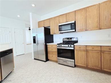 Kitchen with appliances with stainless steel finishes, light countertops, light tile patterned floors, and recessed lighting