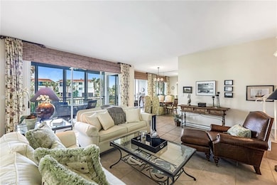 Tiled living room featuring an inviting chandelier