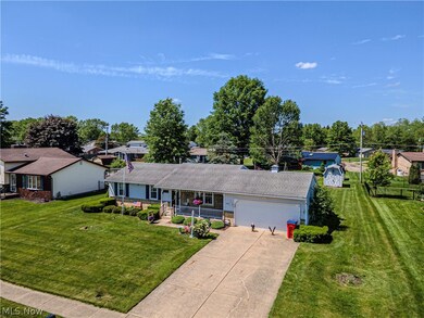 Ranch-style house with a garage and a front yard