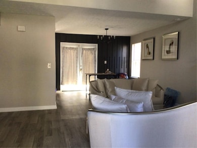 Living area featuring wood finished floors and bas