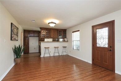 Kitchen featuring dark wood-style flooring, a peni