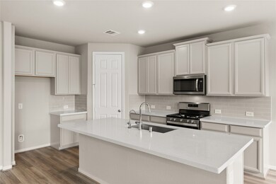 This kitchen is by far any chef’s dream! This spacious kitchen features high ceilings, white stained wood cabinets, quartz countertops, SS appliances, modern tile backsplash, recessed lighting, extended counter space, large kitchen island with space for breakfast bar, and a walk-in pantry all overlooking your huge family room.
