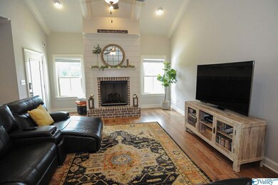 Wood flooring continues through great room with gas fireplace, vaulted ceilings and lake views.