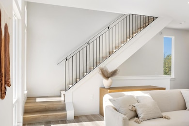 Stairway featuring wood finished floors and baseboards