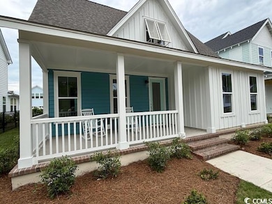 View of front of house featuring board and batten 