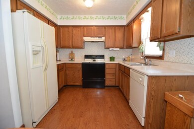 Kitchen is well equipped and overlooks back yard.