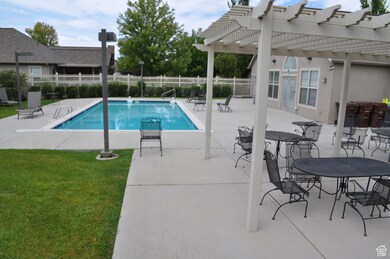 Community pool with a patio and a pergola