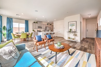 Living area featuring wood finished floors and recessed lighting
Photo is representational only; actual home finishes may vary.