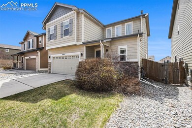 View of front facade with concrete driveway, stone siding, fence, and an attached garage