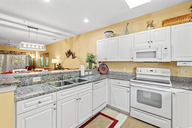 Kitchen with white appliances, a sink, white cabin
