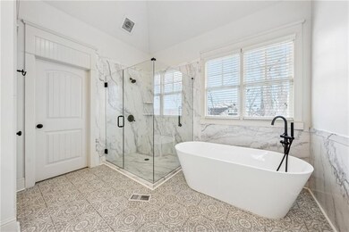 Bathroom with tile patterned floors, a freestandin