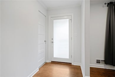 Entryway featuring wood-type flooring and ornament