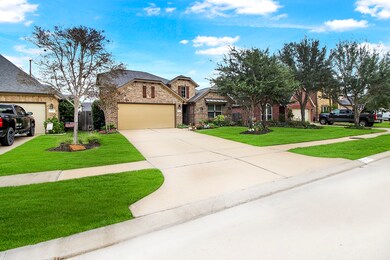 Great Curb Appeal! Another view of the home with the long wide driveway to the 2 car garage. Garage offers a side door.