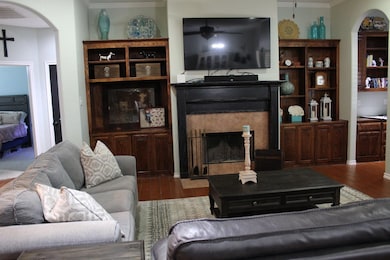 Living area with arched walkways, ornamental mold