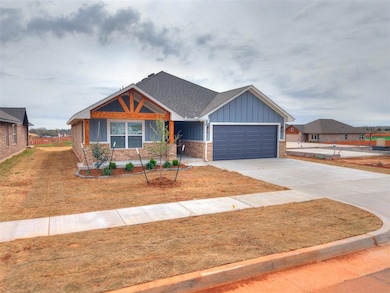 Craftsman house with driveway, brick siding, a gar