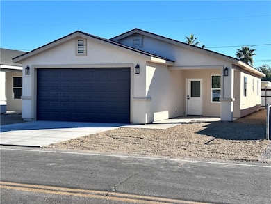 Ranch-style home with stucco siding, concrete driveway, and an attached garage