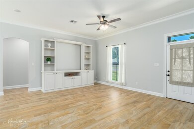 Unfurnished living room featuring light hardwood /