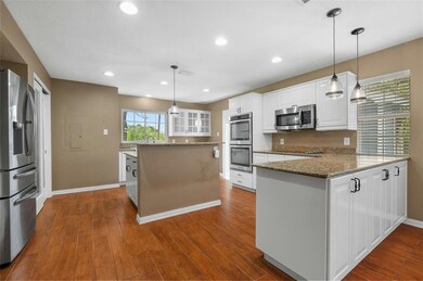 Kitchen with stainless steel appliances, white ca