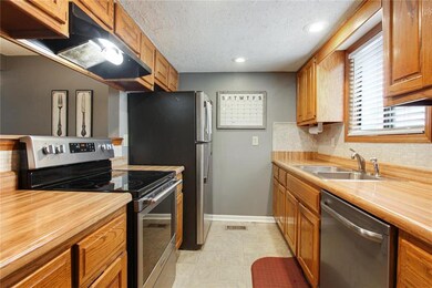 Galley kitchen with lots of cabinets for storage a