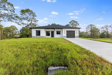 Contemporary home with stucco siding, a garage, dr
