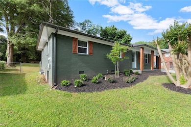 View of front of home with crawl space and brick siding