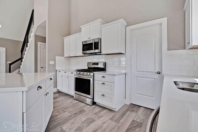 High end stainless, gas cook stove & oven. Stainless builtin microwave and dishwasher. Beautiful subway tile back splash with white granite counter tops and movable island with storage and bar stool seating. Large pantry.