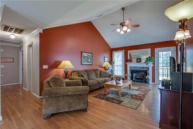 Living room with vaulted ceiling and ceiling fan