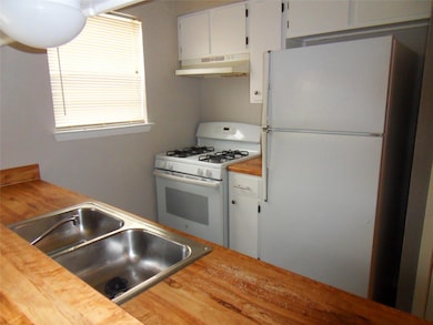Kitchen featuring white cabinets, under cabinet r