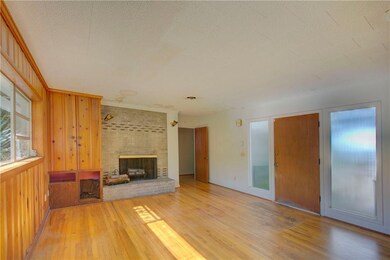 Family room with wood burning fireplace.
