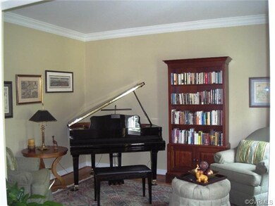 Formal living room is off of foyer with hardwood f